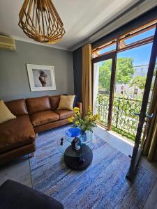 a living room with a couch and a glass table at At Leisure Apartment 2 in Stellenbosch