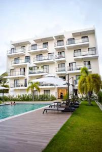 a hotel with a swimming pool and a resort at Downtown Punta Cana-Welcome to our Love Nest! in Punta Cana