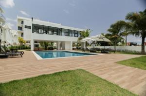 a house with a swimming pool in front of it at Downtown Punta Cana-Welcome to our Love Nest! in Punta Cana