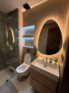 a bathroom with a toilet and a sink and a mirror at bel et comfortable appartement centre agdal in Rabat