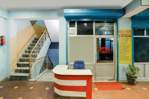 an office with a staircase and a desk in front of a building at SPOT ON Kailash Hotel in Chūharpur