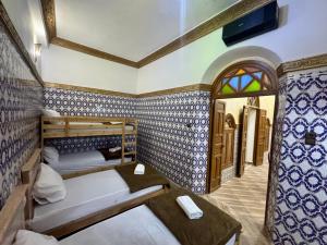 a room with two bunk beds and a window at Riad al anwar in Rabat
