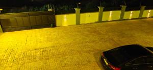 a car parked in a parking lot at night at Purple Springs Elmina Suite #3 in Esamang