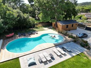 an overhead view of a swimming pool with chairs and a house at N&L Signature - Ô Lodge in Mornas