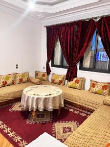 a living room with two couches and a table at Tumsilt in Marrakesh