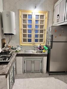 a kitchen with a sink and a refrigerator at Tumsilt in Marrakesh +18 photos