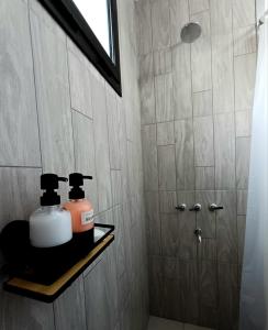 een badkamer met twee zeepflessen op een plank bij Casa quinta - El descanso in Olavarría