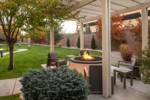 a patio with a fire pit in a yard at Courtyard Carson City in Carson City