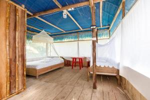 a bedroom with a bed and a table in a room at Red Uakari Jungle Lodge in Iquitos