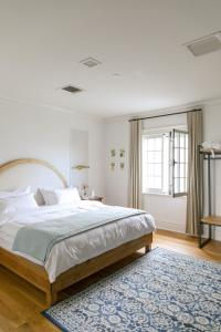 Auberge Willow Inn في Hudson: غرفة نوم بسرير كبير وسجادة زرقاء