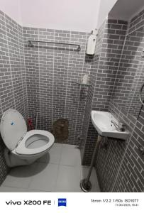 a bathroom with a toilet and a sink at Pink Floyd in Pushkar