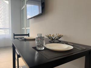 a black table with a plate and a glass on it at Видові Апартаменти ЖК GREAT in Kyiv +8 photos