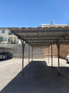 a large wooden canopy in a parking lot at Departamento Liban in San Juan