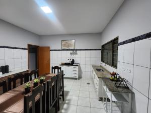 a large kitchen with a table and chairs in it at Hotel Pousada Narandiba in Narandiba +22 photos