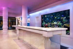 an aquarium in a room with a large fish tank at The Gallivant Times Square in New York