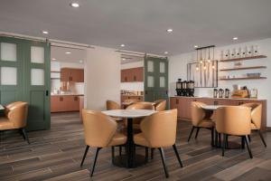a kitchen and dining room with a table and chairs at Residence Inn Pearland in Pearland