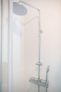 a shower with a shower head in a bathroom at Saint-Fons centre appartement meublé in Saint-Fons