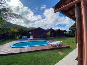 a swimming pool in a yard with tents at Green Mountain Pousada in Florianópolis