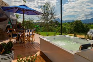 a jacuzzi tub on the deck of a house at Prana Hills in Estación El Salto +24 photos
