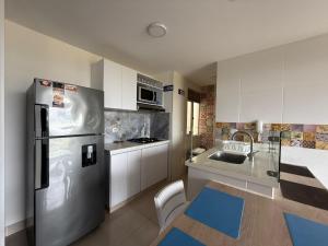 Η κουζίνα ή μικρή κουζίνα στο Tu escapada perfecta te espera, Apto de lujo y confort en conjunto cerrado