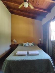 a bedroom with a bed with two towels on it at La Posada del Mar in Miramar +64 photos
