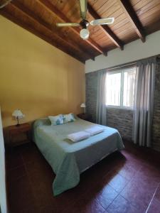a bedroom with a bed with two towels on it at La Posada del Mar in Miramar