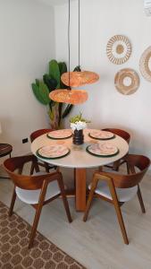 a dining room table with four plates and chairs at Green Oasis in La Laguna