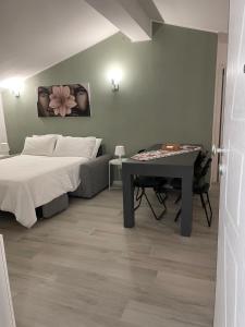 a bedroom with a bed and a table in it at PsApart in Augusta