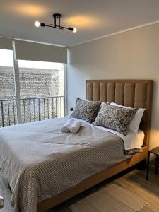 Postel nebo postele na pokoji v ubytování Condominio Beauchef 1916