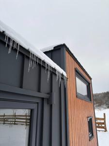 a house with icicles hanging off the side of it at Jemiołucha Glamp in Bodzentyn