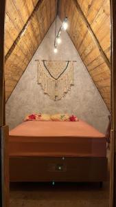 a bedroom with a bed in a attic at Camping Proibido Não Viver in Cruz