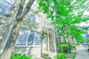 a house with a tree in front of it at The Urban Family Pad in Toronto