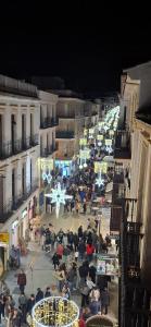 a crowd of people sitting in a courtyard at night at Nunes Luxury in Ronda
