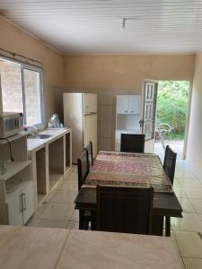 a kitchen with a table with chairs and a refrigerator at Favale in Rivera