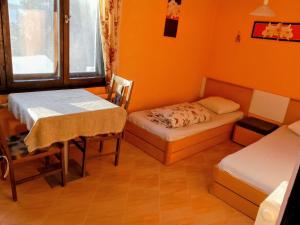 a room with two beds and a table in it at Hostel Varna Botanika in Varna City