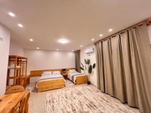 Ένα ή περισσότερα κρεβάτια σε δωμάτιο στο Deluxe SIWA