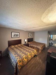 a hotel room with two beds and a desk at Executive Inn Coopersburg in Coopersburg
