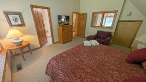a hotel room with a bed and a television at Circle 4 Condo 14 in Sunriver
