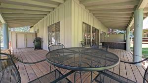a patio with a table and chairs on a porch at Circle 4 Condo 14 in Sunriver