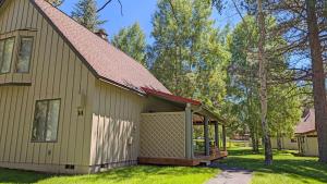 a house with a covered porch on the side of it at Circle 4 Condo 14 in Sunriver