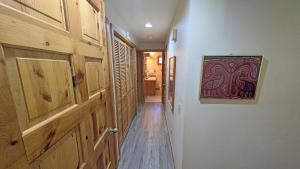a hallway with wooden doors and a painting on the wall at Circle 4 Condo 14 in Sunriver +23 photos