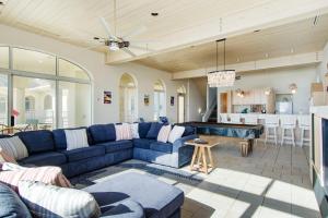 Chateau of the Isle by Emerald Isle Realty في Salter Path: غرفة معيشة مع أريكة زرقاء وطاولة بلياردو