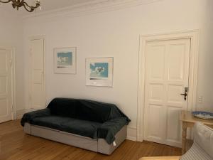 a dog bed in a room with a white wall at Topcity in Copenhagen +2 photos