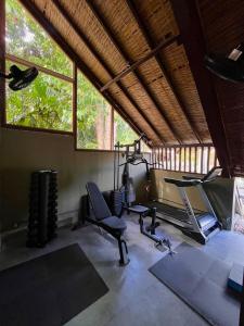 a gym with two exercise bikes and a treadmill at Pousada Arraial Candeia in Arraial d'Ajuda