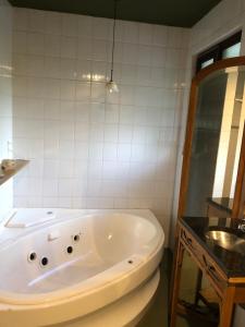 a bath tub sitting in a bathroom next to a mirror at Cuatro Cerros in San Carlos de Bariloche +30 photos