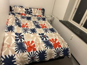 a bed in a small room with a white and blue at Kiko in Horsens