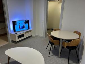 a room with two tables and a flat screen tv at Kiko in Horsens