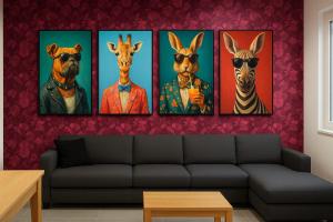 four paintings of animals on a wall in a living room at SuiteDreams - Ruby Suite Liège in Liège