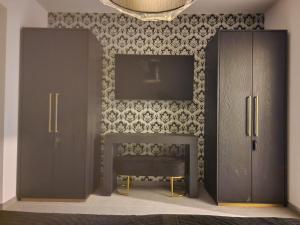 a living room with a fireplace and two wooden cabinets at SuiteDreams - Ruby Suite Liège in Liège