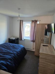 a bedroom with a bed and a window at Lantern House in Bristol